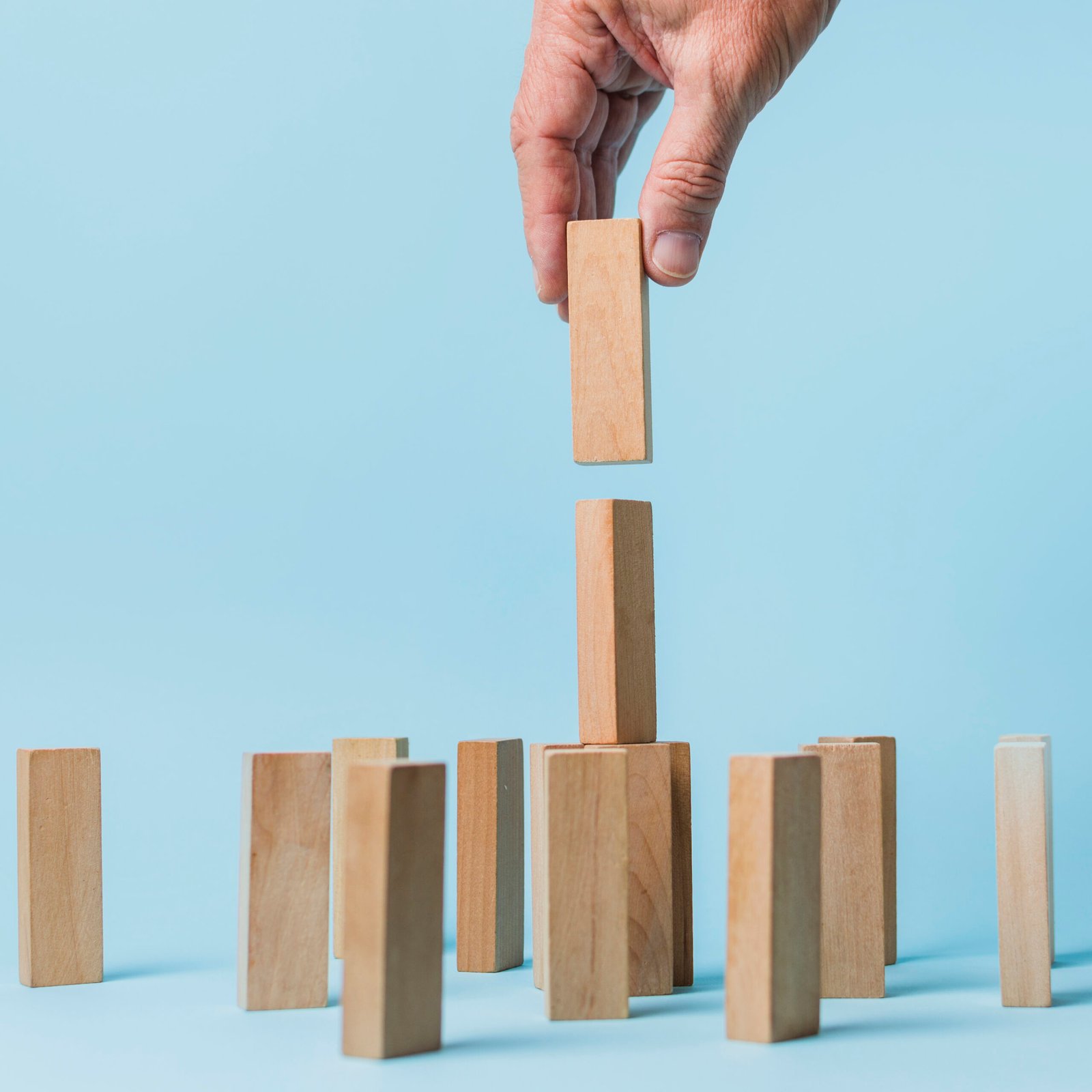 businessman-using-wooden-pieces businessman-using-wooden-pieces